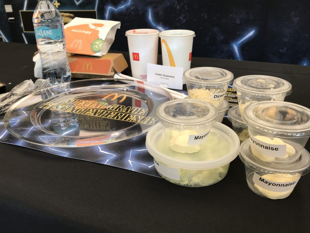 Various McDonald's ingredients accompanied with the Special grade Garlic Sauce next to an empty plate to create the menu items at the DOY tasting event. 